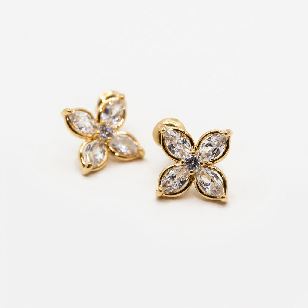 Pair of gold stud earrings on white background