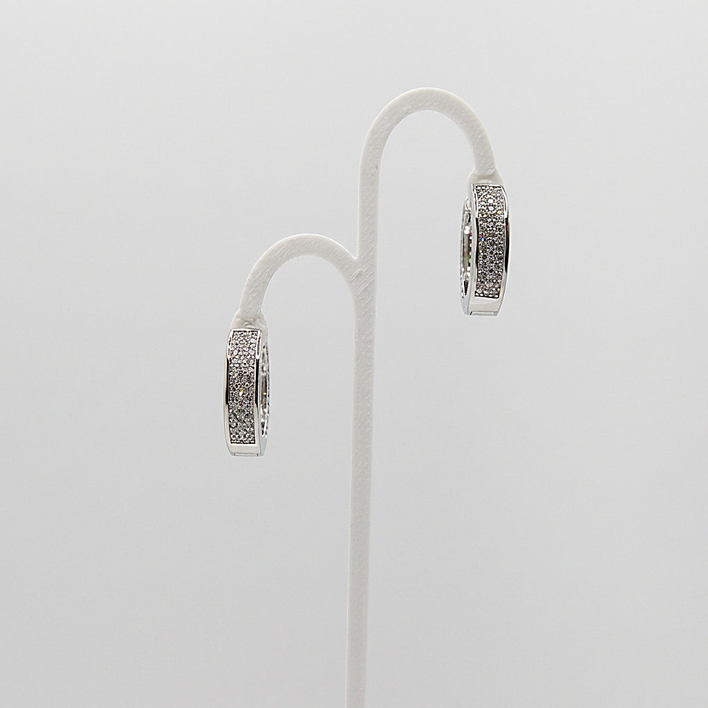 Pair of silver hoop earrings on white background