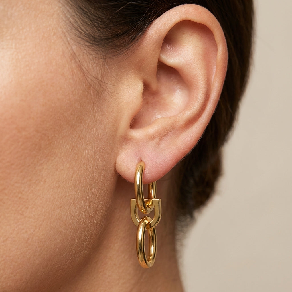 Model wearing gold drop earrings showing scale