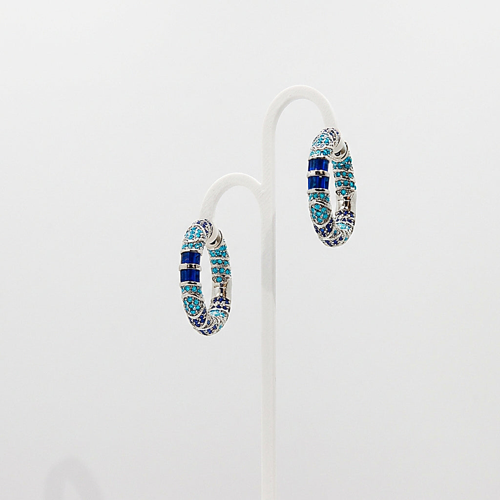 Pair of silver hoop earrings on white background