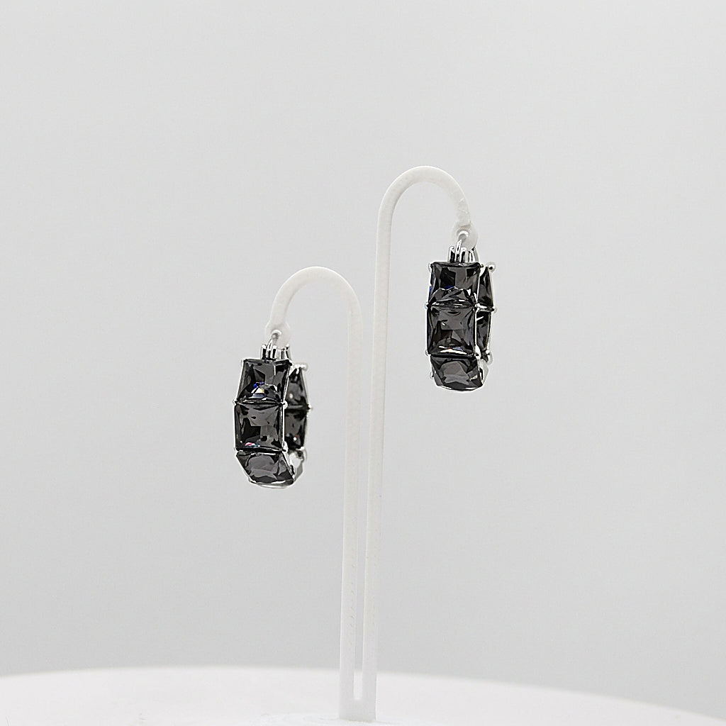 Pair of silver hoop earrings on white background