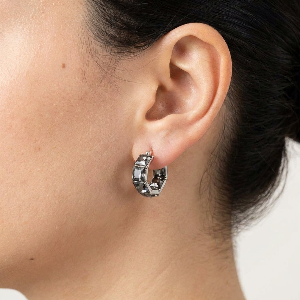 Model wearing silver hoop earrings showing scale