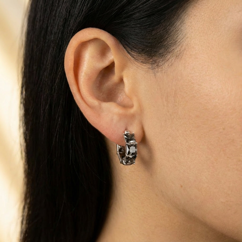 Model wearing silver hoop earrings showing scale