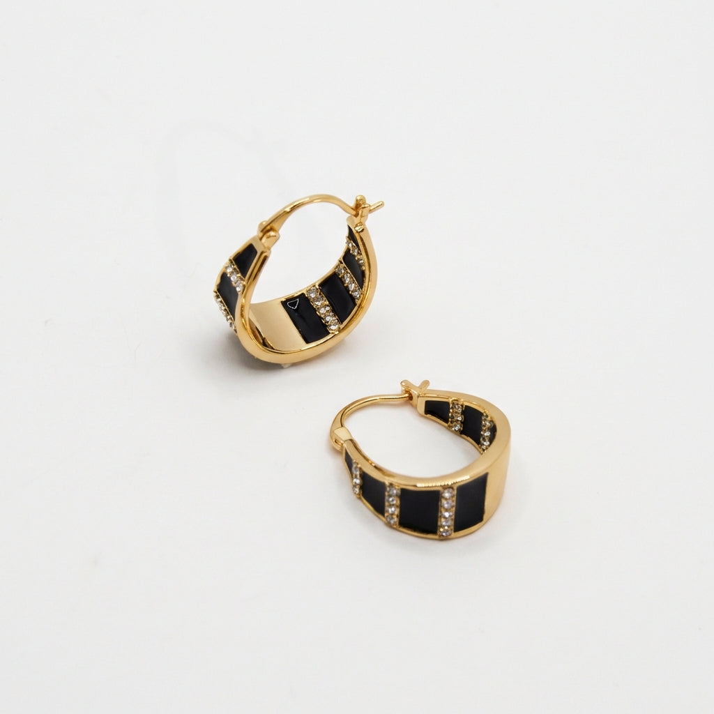 Pair of gold hoop earrings on white background