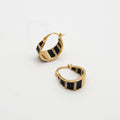 Pair of gold hoop earrings on white background
