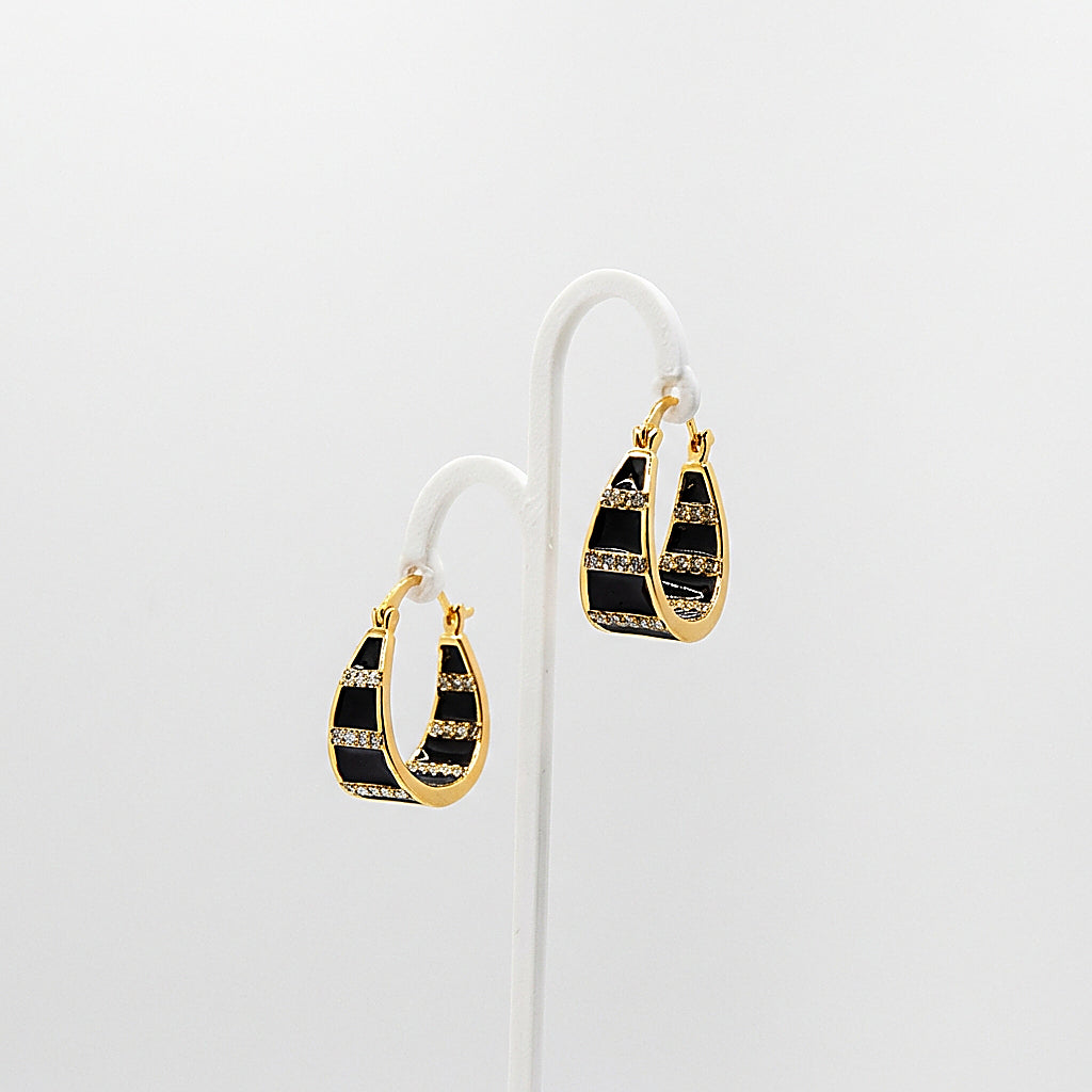 Pair of gold hoop earrings on white background