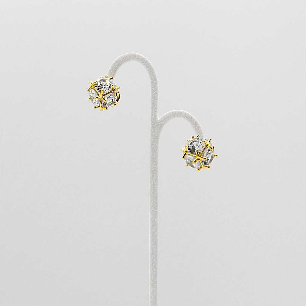 Pair of gold studs on white background