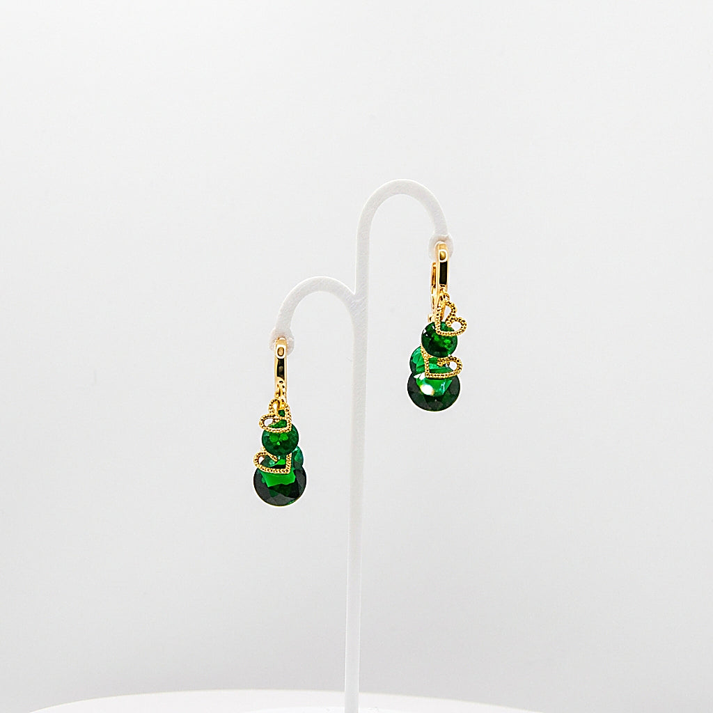 Pair of gold drop earrings on white background