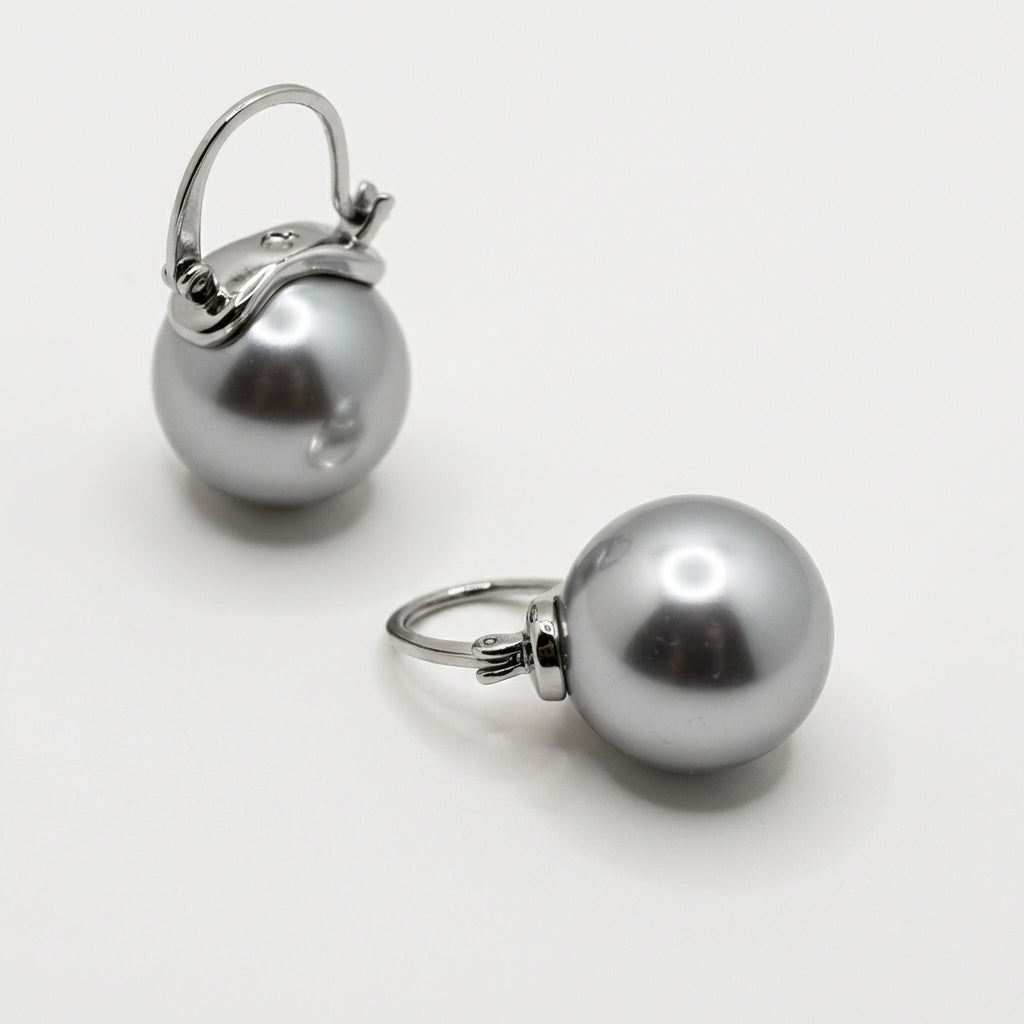 Pair of silver leverback earrings on white background